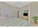 Bright bedroom features a four-poster bed, ceiling fan, and a full closet at 13241 Scrub Jay Ct, Port Charlotte, FL 33953