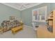 Cozy bedroom includes a pull-out sofa, desk, and a large window with plantation shutters at 13241 Scrub Jay Ct, Port Charlotte, FL 33953