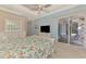 Spacious bedroom includes a large window, sliding glass doors to a patio, and light-colored furniture at 13241 Scrub Jay Ct, Port Charlotte, FL 33953