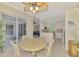 Dining area with views into the kitchen, living area, and screened patio with outdoor seating at 13241 Scrub Jay Ct, Port Charlotte, FL 33953