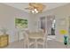 Dining area featuring a ceiling fan, a large painting, and sliding glass doors to the outdoor patio at 13241 Scrub Jay Ct, Port Charlotte, FL 33953