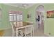 Dining area featuring plantation shutters on the windows and an archway leading into the kitchen at 13241 Scrub Jay Ct, Port Charlotte, FL 33953