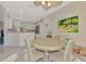 Cozy dining area with a round table, four chairs, and is open to the kitchen area at 13241 Scrub Jay Ct, Port Charlotte, FL 33953