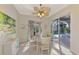 Dining area with ceiling fan, painting, and sliding glass doors that lead to screened in lanai and pool at 13241 Scrub Jay Ct, Port Charlotte, FL 33953