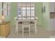 Bright dining area with plantation shutters on the window and a view to the kitchen at 13241 Scrub Jay Ct, Port Charlotte, FL 33953