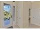 Bright foyer featuring glass front door with palm tree design and doorways to other rooms at 13241 Scrub Jay Ct, Port Charlotte, FL 33953