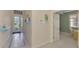 Inviting foyer with tile flooring, stylish decorations, and doorway to home office at 13241 Scrub Jay Ct, Port Charlotte, FL 33953