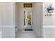 Inviting front entrance showcasing glass front door, sconce, and clearly visible address number at 13241 Scrub Jay Ct, Port Charlotte, FL 33953