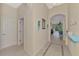 Neutral hallway with tiled floors leads to the living room and bedrooms, offering ample natural light at 13241 Scrub Jay Ct, Port Charlotte, FL 33953