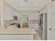 Well-equipped kitchen with stainless steel appliances, white cabinetry, and open to the dining area at 13241 Scrub Jay Ct, Port Charlotte, FL 33953