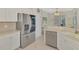 Bright kitchen features stainless steel appliances and white cabinetry with plenty of storage space at 13241 Scrub Jay Ct, Port Charlotte, FL 33953