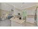 Modern kitchen overlooking the living area featuring white cabinets, stainless steel appliances, and open design at 13241 Scrub Jay Ct, Port Charlotte, FL 33953