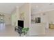Spacious living room with tile floors, open to kitchen and views to the front entrance and dining area at 13241 Scrub Jay Ct, Port Charlotte, FL 33953