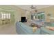 Open-concept living room with tile floors, comfortable seating, and views to the dining area and outdoor patio at 13241 Scrub Jay Ct, Port Charlotte, FL 33953
