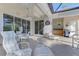 Covered patio features outdoor seating, a grill, and a door to the cabana bath at 13241 Scrub Jay Ct, Port Charlotte, FL 33953