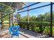 Enclosed patio featuring outdoor seating offers views of lush landscaping at 13241 Scrub Jay Ct, Port Charlotte, FL 33953