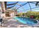 Enjoy outdoor living with a spacious, screened pool and adjacent patio at 13241 Scrub Jay Ct, Port Charlotte, FL 33953