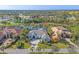 Stunning aerial view of the home with water view and mature landscaping in a desirable community at 15 Boca Royale Blvd, Englewood, FL 34223