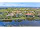 Aerial view of beautiful homes situated on a lake, surrounded by lush landscaping and golf course at 15 Boca Royale Blvd, Englewood, FL 34223