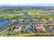 Aerial view showcasing residential community with lakes, tennis courts and a golf course at 15 Boca Royale Blvd, Englewood, FL 34223