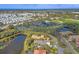 Panoramic aerial view showcasing golf course and residential community near lake and amenities at 15 Boca Royale Blvd, Englewood, FL 34223