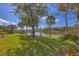 Expansive backyard with mature trees and tranquil lake views, perfect for outdoor enjoyment at 15 Boca Royale Blvd, Englewood, FL 34223