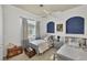 Charming bedroom with twin beds, nautical decor, and natural light at 15 Boca Royale Blvd, Englewood, FL 34223