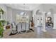 Elegant dining room with large windows, chandelier, and ample space for entertaining at 15 Boca Royale Blvd, Englewood, FL 34223