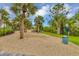 Dog park features sandy area with mature landscaping and trees at 15 Boca Royale Blvd, Englewood, FL 34223