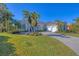 Beautiful single-story home featuring an oversized driveway, 3 car garage, lush landscaping and ample natural light at 15 Boca Royale Blvd, Englewood, FL 34223