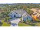 Stately single-story home boasting lush landscaping, a 3 car garage, and a paver driveway at 15 Boca Royale Blvd, Englewood, FL 34223