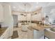 Bright kitchen featuring white cabinets, granite countertops, bar seating, and a breakfast nook at 15 Boca Royale Blvd, Englewood, FL 34223