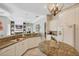 Bright kitchen with granite countertops, white cabinetry, and open floor plan at 15 Boca Royale Blvd, Englewood, FL 34223
