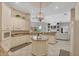 Bright kitchen featuring white cabinets, granite countertops, an island, and modern appliances at 15 Boca Royale Blvd, Englewood, FL 34223