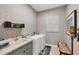 Functional laundry room with modern washer, dryer, and patterned wallpaper at 15 Boca Royale Blvd, Englewood, FL 34223