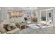 Open-concept living room and kitchen area leading to patio at 15 Boca Royale Blvd, Englewood, FL 34223