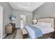 Calm main bedroom featuring tray ceiling, with dresser and ensuite access at 15 Boca Royale Blvd, Englewood, FL 34223