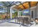 Outdoor kitchen under screened-in patio, perfect for entertaining with lake view at 15 Boca Royale Blvd, Englewood, FL 34223
