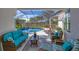 Relaxing screened-in patio with comfortable seating overlooking the pool at 15 Boca Royale Blvd, Englewood, FL 34223