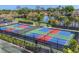 Overhead view of vibrant pickleball courts with colorful surfaces, surrounded by well-kept landscaping at 15 Boca Royale Blvd, Englewood, FL 34223