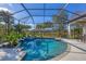 A screened in pool and patio area featuring a spa, outdoor kitchen and beautiful lake views at 15 Boca Royale Blvd, Englewood, FL 34223