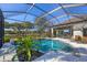 A screened in pool and patio area featuring a spa, outdoor kitchen and beautiful lake views at 15 Boca Royale Blvd, Englewood, FL 34223