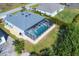 An aerial view reveals a home with a screened pool and green, landscaped yard at 15081 Aldama Cir, Port Charlotte, FL 33981