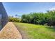 Backyard features tropical foliage, a rock garden, and plenty of room to entertain at 15081 Aldama Cir, Port Charlotte, FL 33981