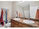 Bathroom features a double sink vanity, decorative beach sign and neutral decor at 15081 Aldama Cir, Port Charlotte, FL 33981