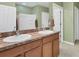 Bathroom featuring a double sink vanity and neutral decor for a clean, modern aesthetic at 15081 Aldama Cir, Port Charlotte, FL 33981