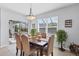 Inviting dining area with backyard views, elegant furnishings, and seamless access to outdoor spaces, ideal for gatherings at 15081 Aldama Cir, Port Charlotte, FL 33981