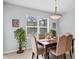 Elegant dining room with a stylish table setting, bright window, and charming decor, ideal for hosting at 15081 Aldama Cir, Port Charlotte, FL 33981