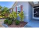Close-up of a front entrance with lush tropical plants, showcasing curb appeal at 15081 Aldama Cir, Port Charlotte, FL 33981