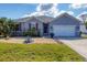 Charming single-story home with well-maintained landscaping and a two-car garage at 15081 Aldama Cir, Port Charlotte, FL 33981